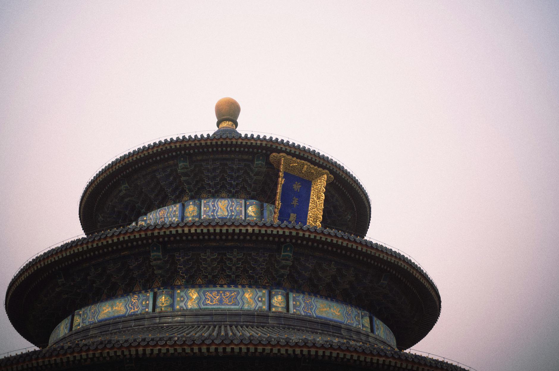 The iconic Temple of Heaven pavilion against a serene dusk sky in Beijing, China.