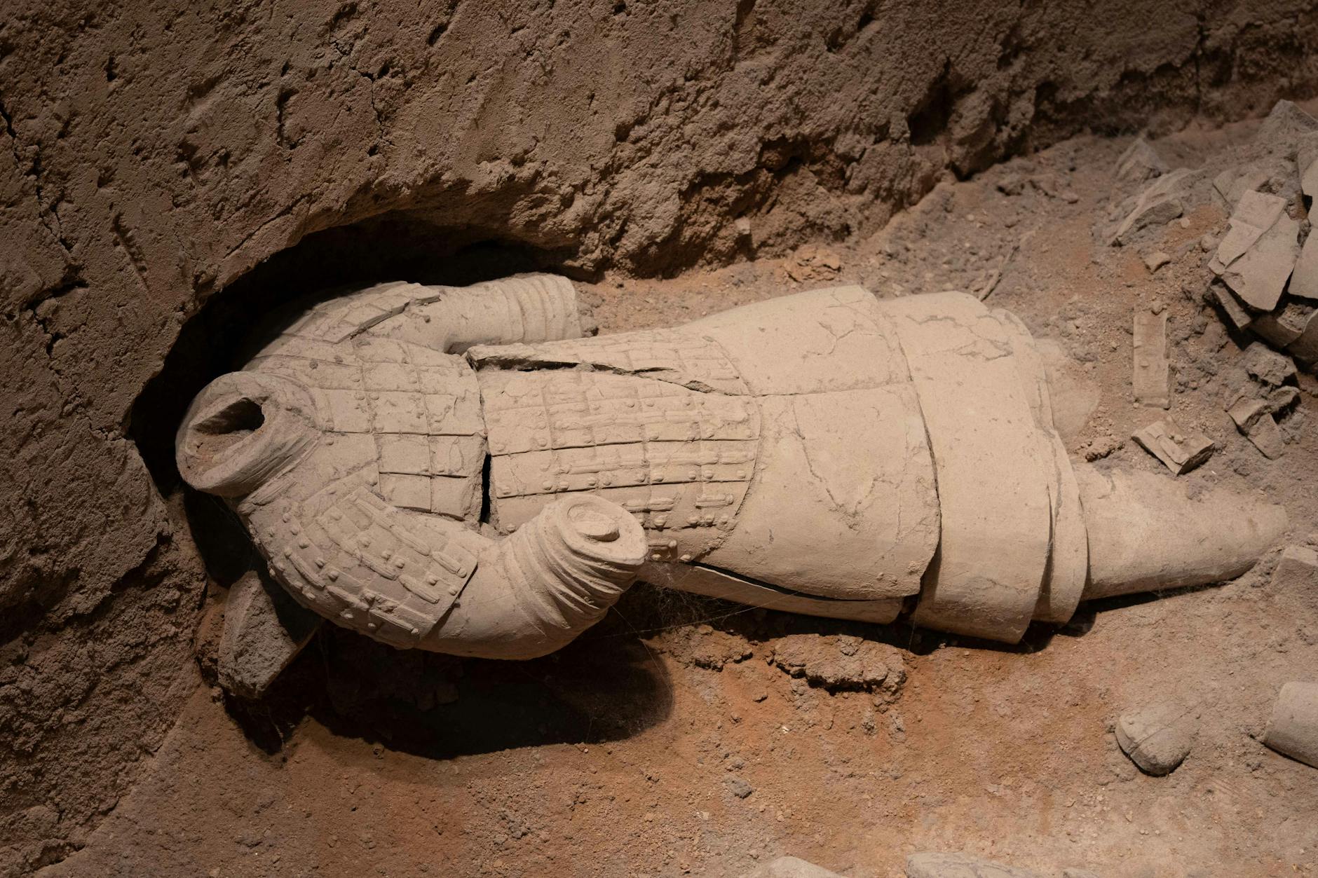 A fallen Terracotta Warrior amidst ruins in Xi'an, Shaanxi, China.