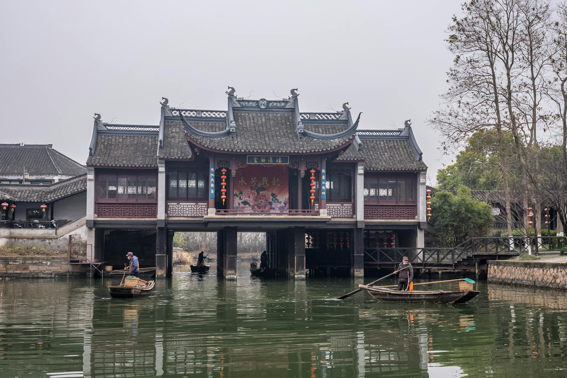 Serene scene of traditional Chinese building over a canal with boats in Zhujiajiao, China.