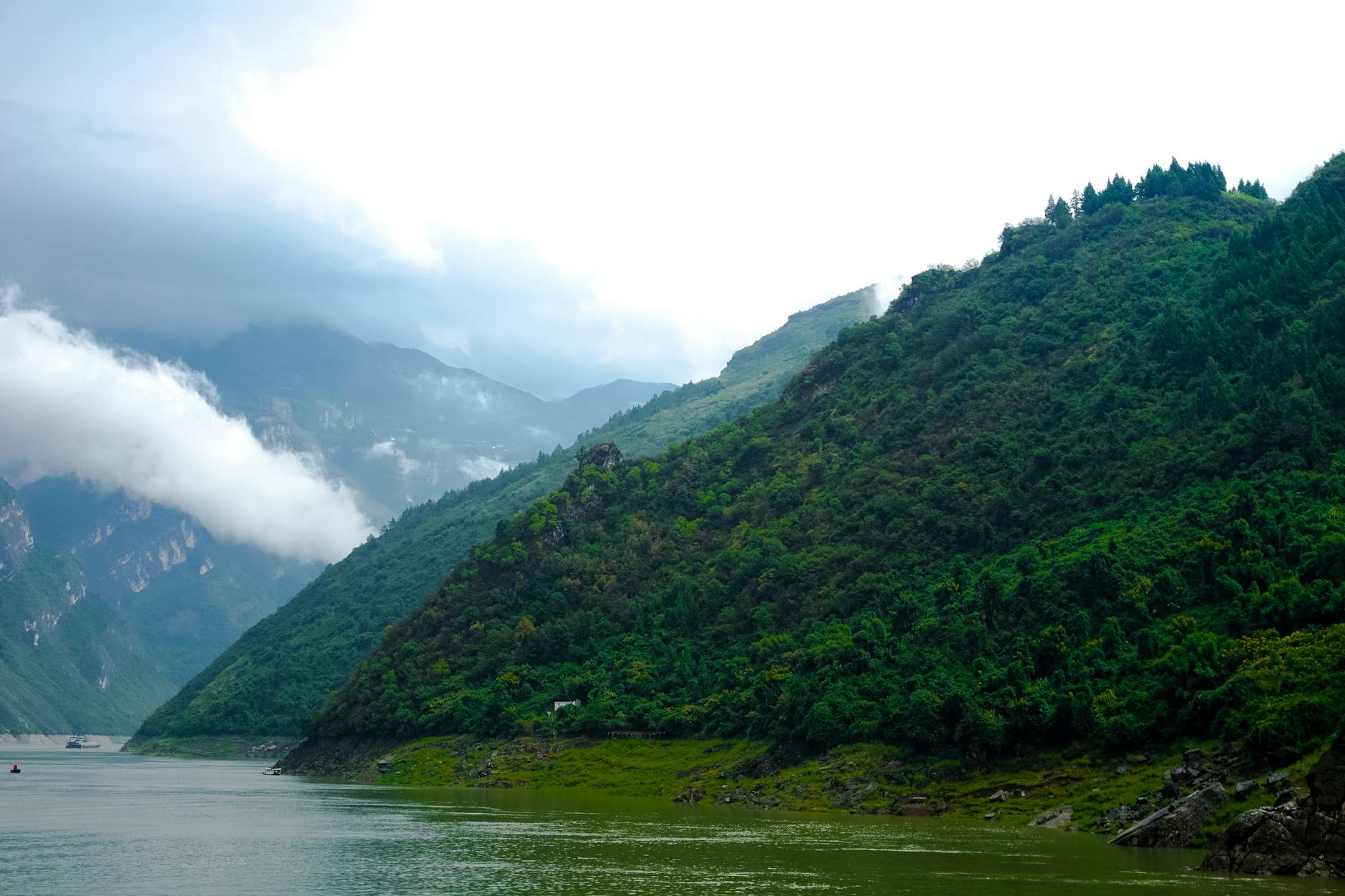 Breathtaking view of lush mountains and serene lake in China's stunning landscape.