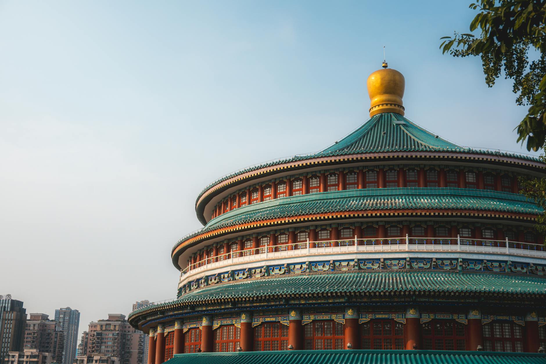 Stunning shot of Chongqing People's Hall showcasing traditional Chinese architecture against cityscape.