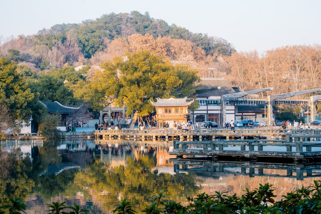 Peaceful lake reflecting traditional buildings and trees