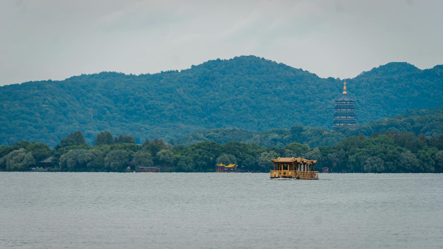 Picturesque view of West Lake with pagoda and boat, Hangzhou, China.