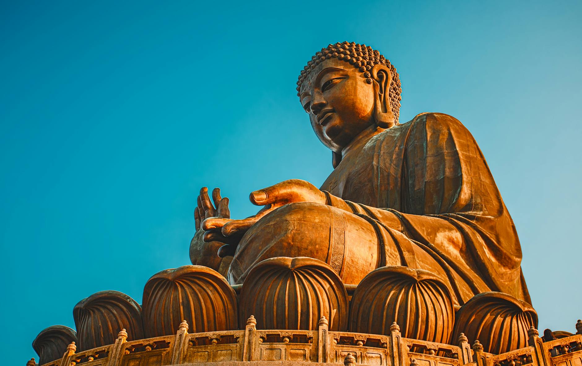 Majestic Tian Tan Buddha statue in Hong Kong's New Territories under a clear blue sky.