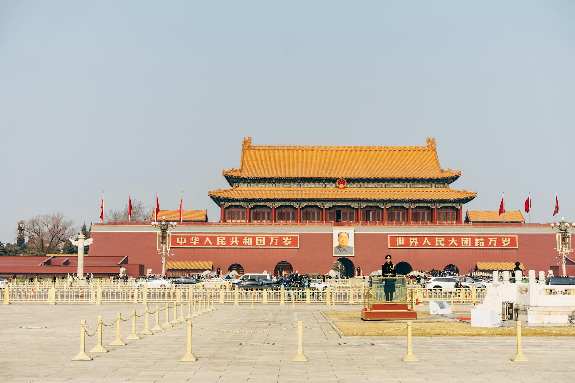 Explore the iconic Tiananmen Square with historic architecture under a clear blue sky.