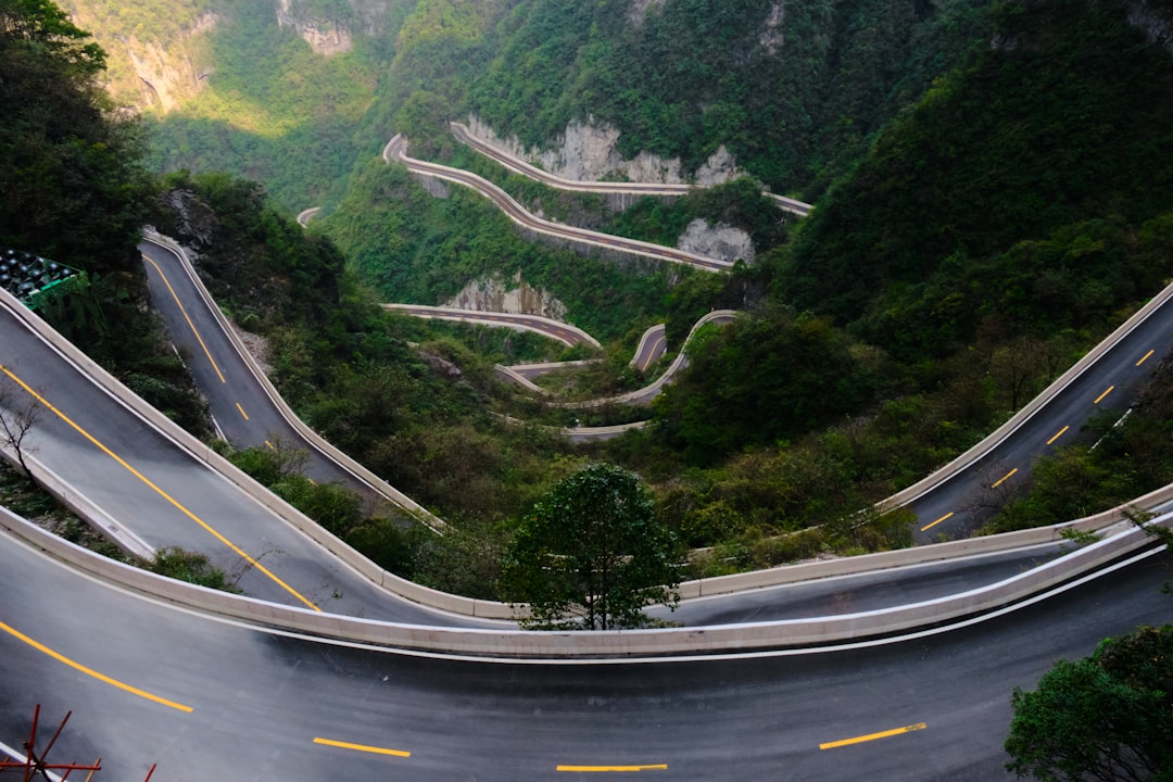 Winding mountain road with sharp turns and lush green foliage