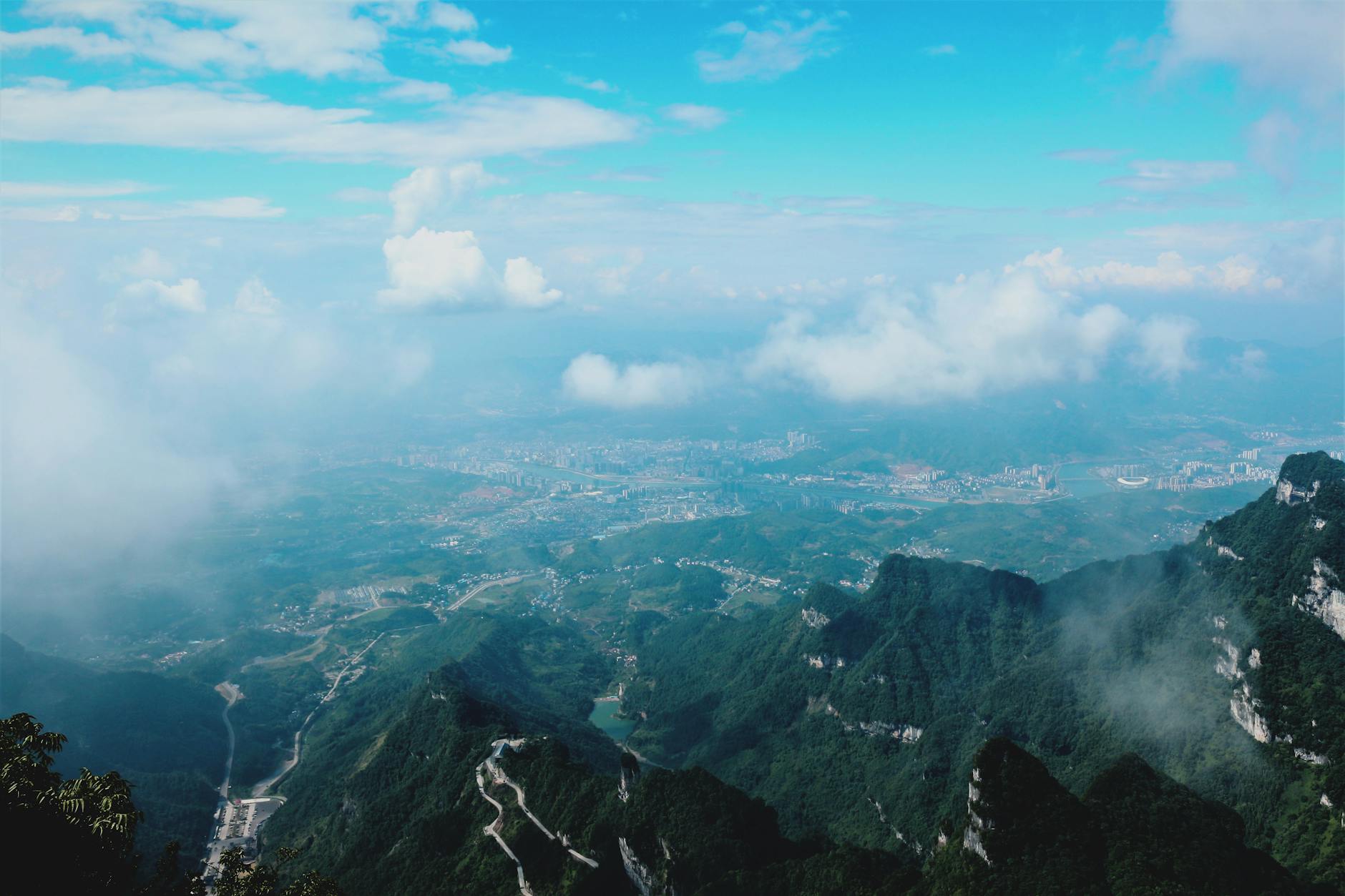 High angle view of misty mountains and valleys with a stunning sky.