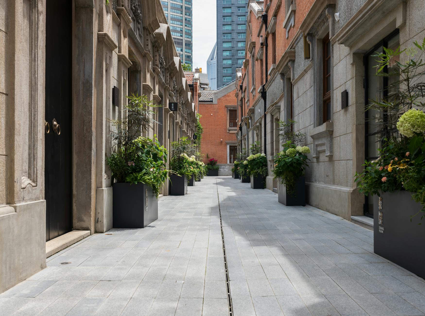 A picturesque urban alley in Jing An Qu, showcasing modern and classic architecture in Shanghai, China.