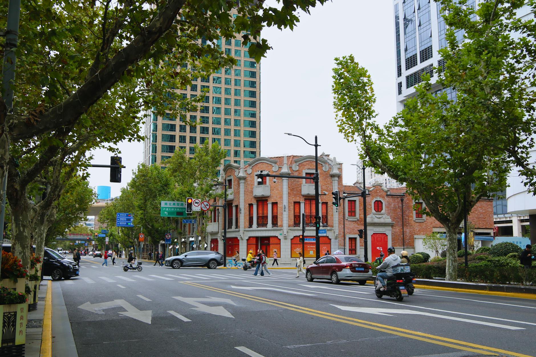 Lively street in Xangai, China showcasing modern and traditional architecture.