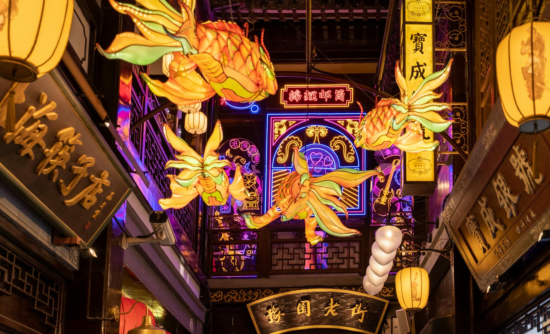 Colorful lantern display illuminating a bustling urban alley at night.