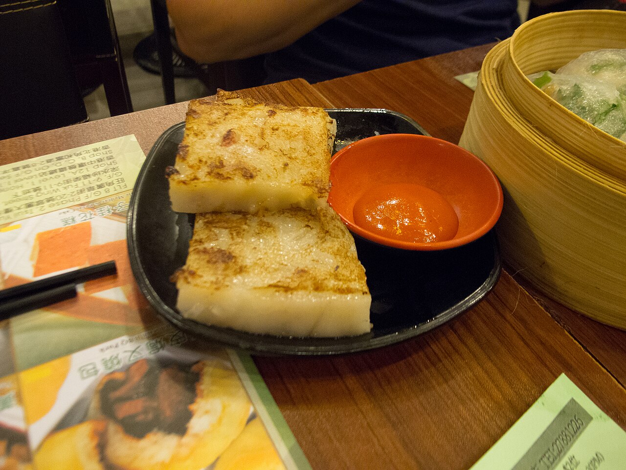 Cakes are made from mashed daikon radish mixed with bits of dried shrimp and pork sausage that are steamed and then cut into slices and pan-fried.
<a href="h