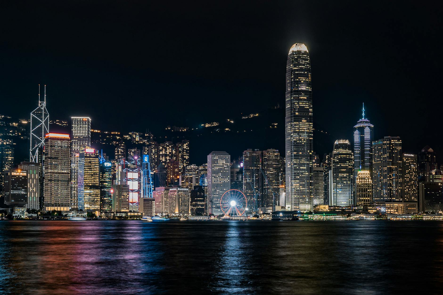 Captivating night view of Hong Kong's skyline reflecting over Victoria Harbour.