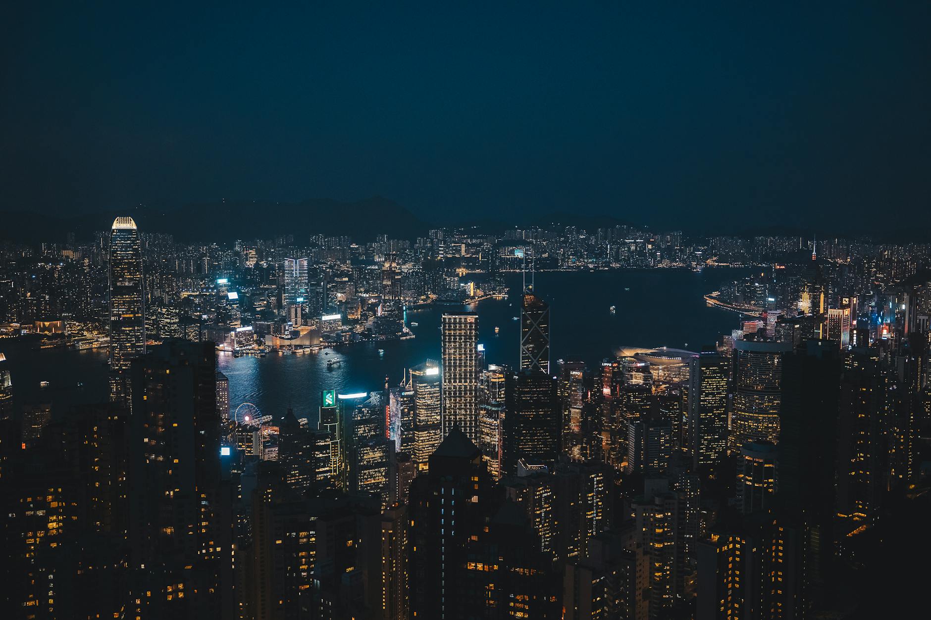 Breathtaking night cityscape of Hong Kong Island's vibrant skyline overlooking the harbor.