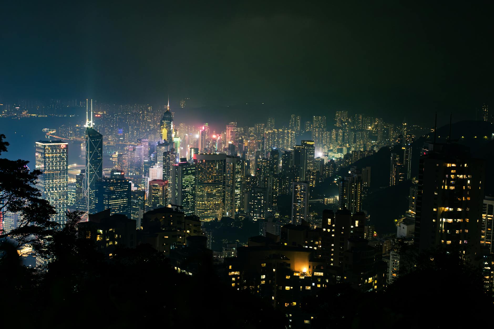 Beautiful illuminated skyline of Hong Kong city at night with towering skyscrapers and vibrant lights.