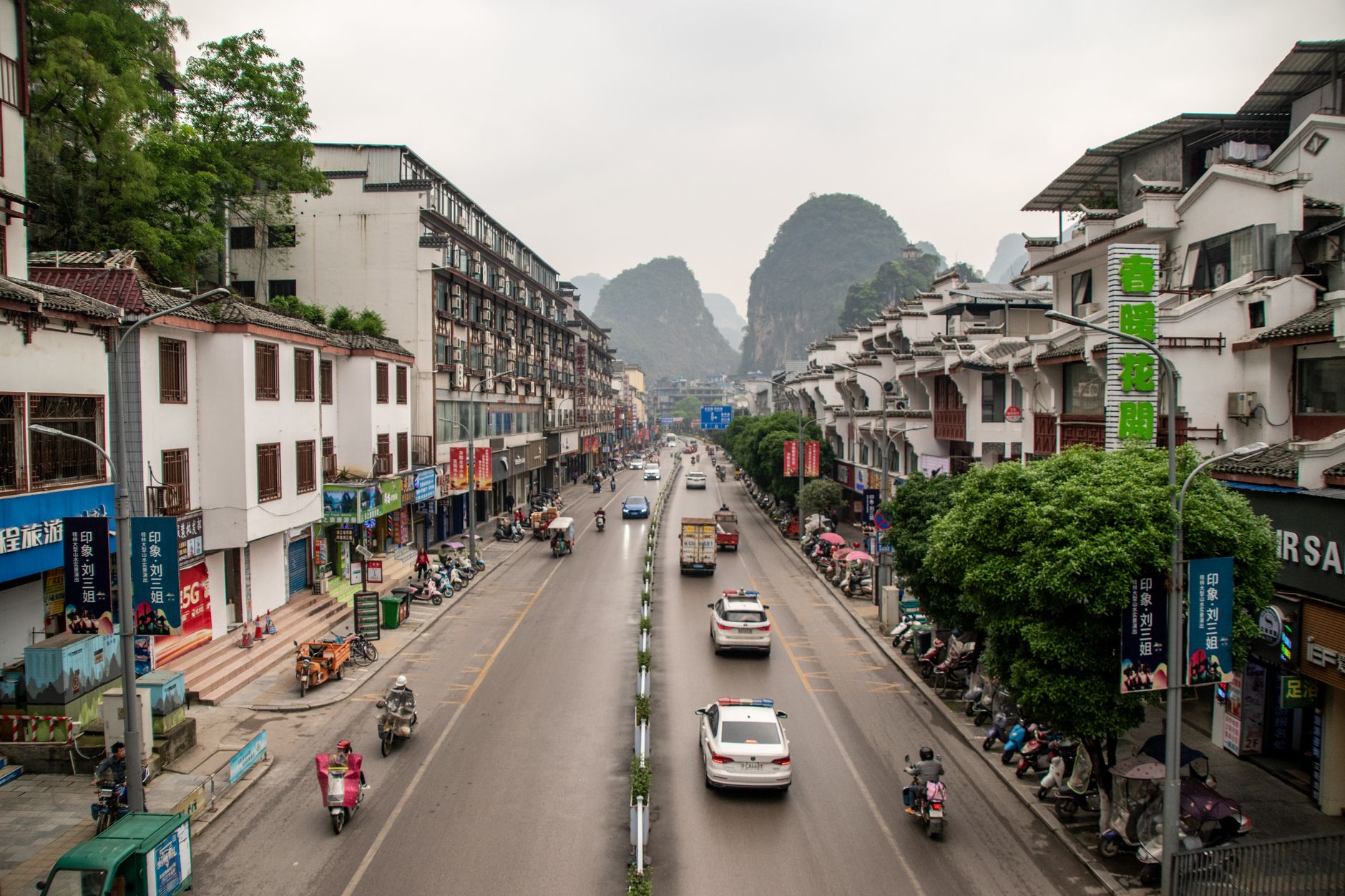 Vibrant urban street in Yangzhou, China, showcasing local architecture and traffic.