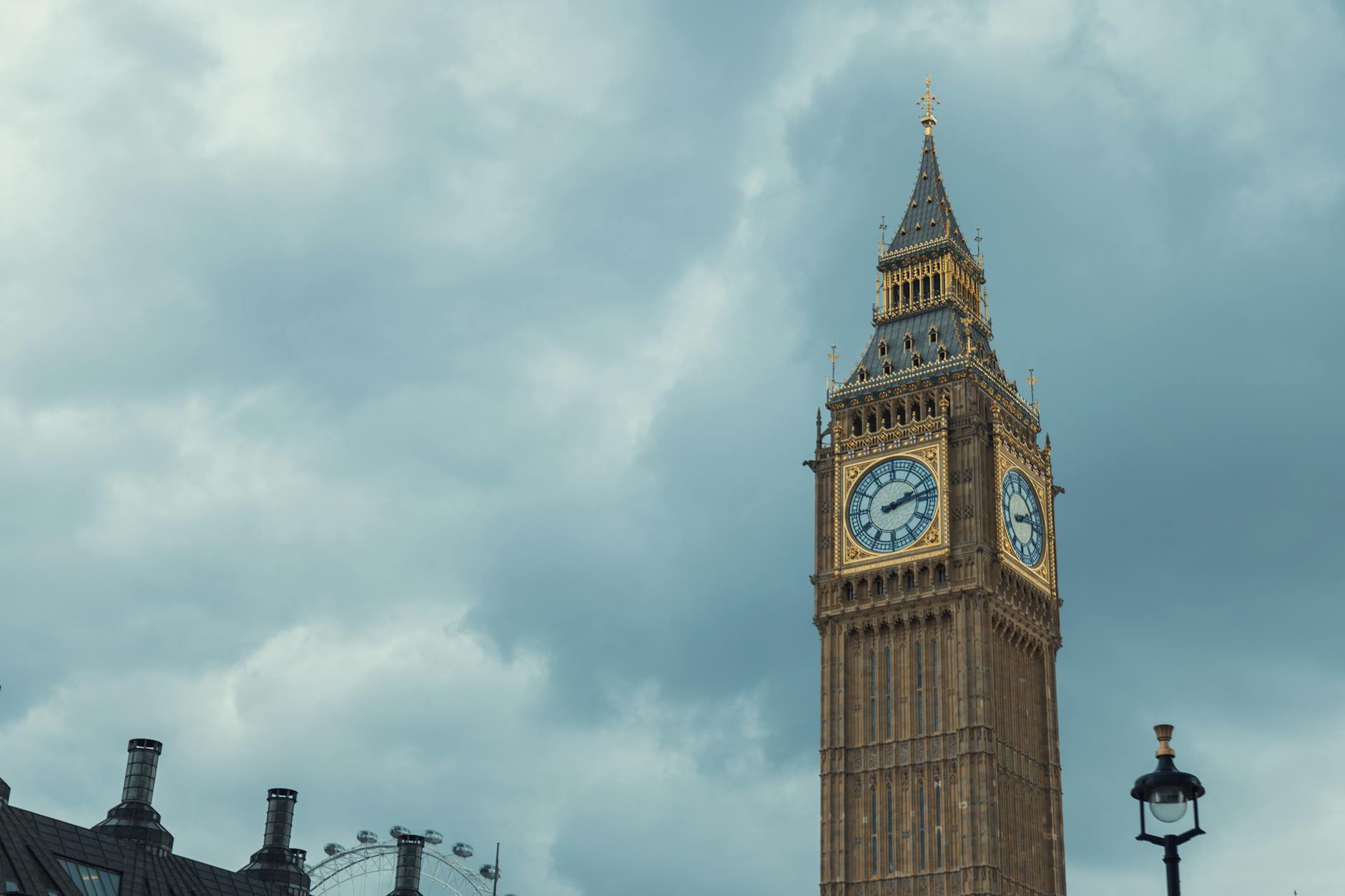 Close-up view of Big Ben with dramatic clouds, showcasing London's iconic architecture.