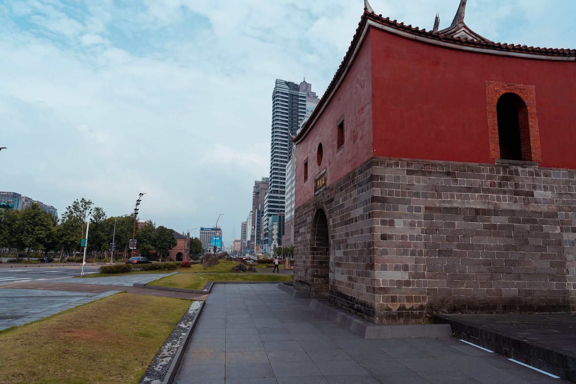 Red brick traditional architecture with cityscape backdrop, ideal for travel and architecture themes.