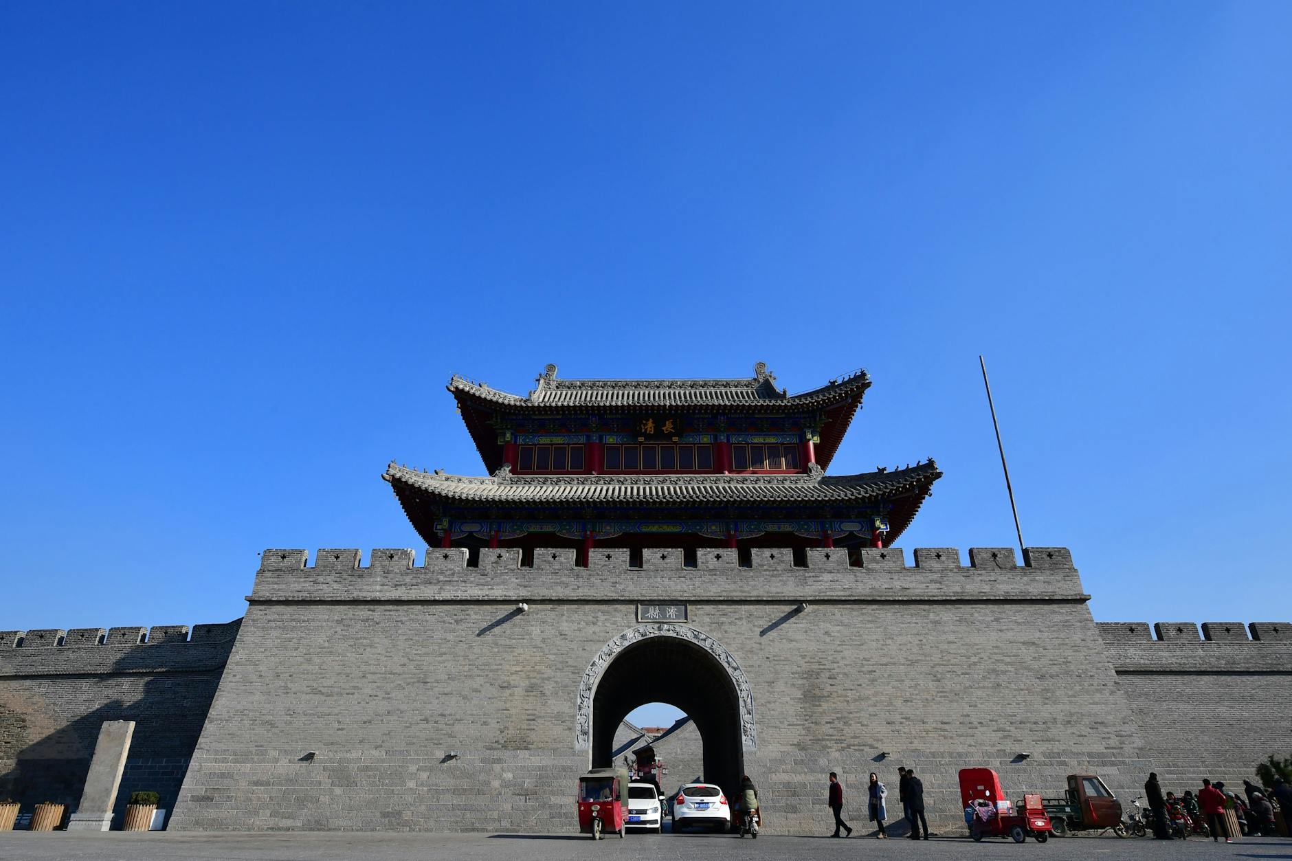 Beautiful front view of the iconic gate in Jingzhou, showcasing traditional Chinese architecture under a clear blue sky.