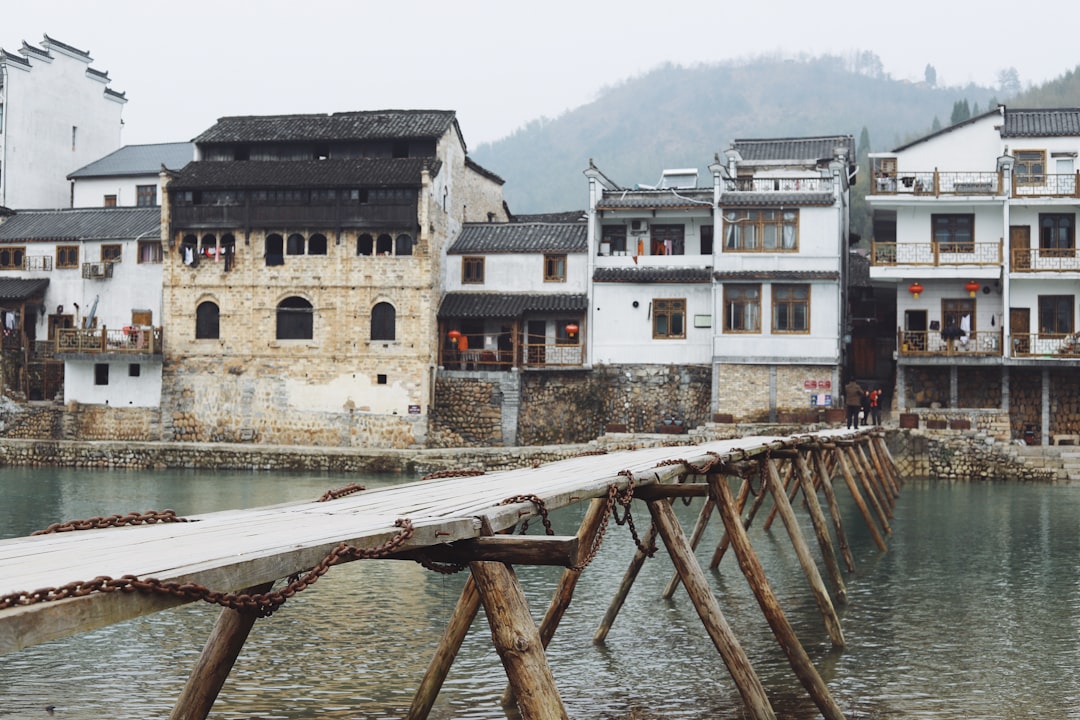 foot bridge on the body of water during low tide