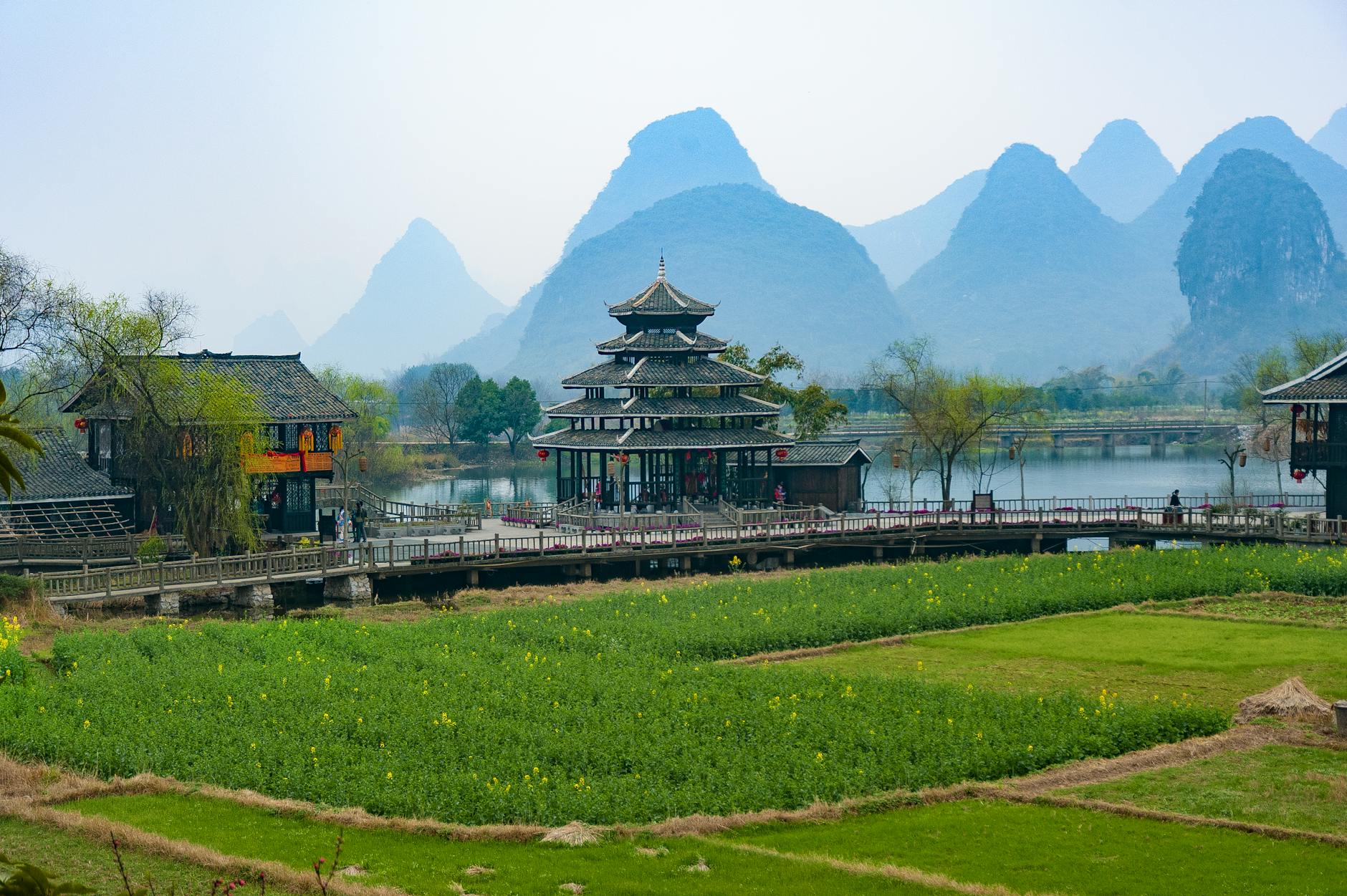 Picturesque view of traditional Chinese architecture and mountains in Guilin, China.