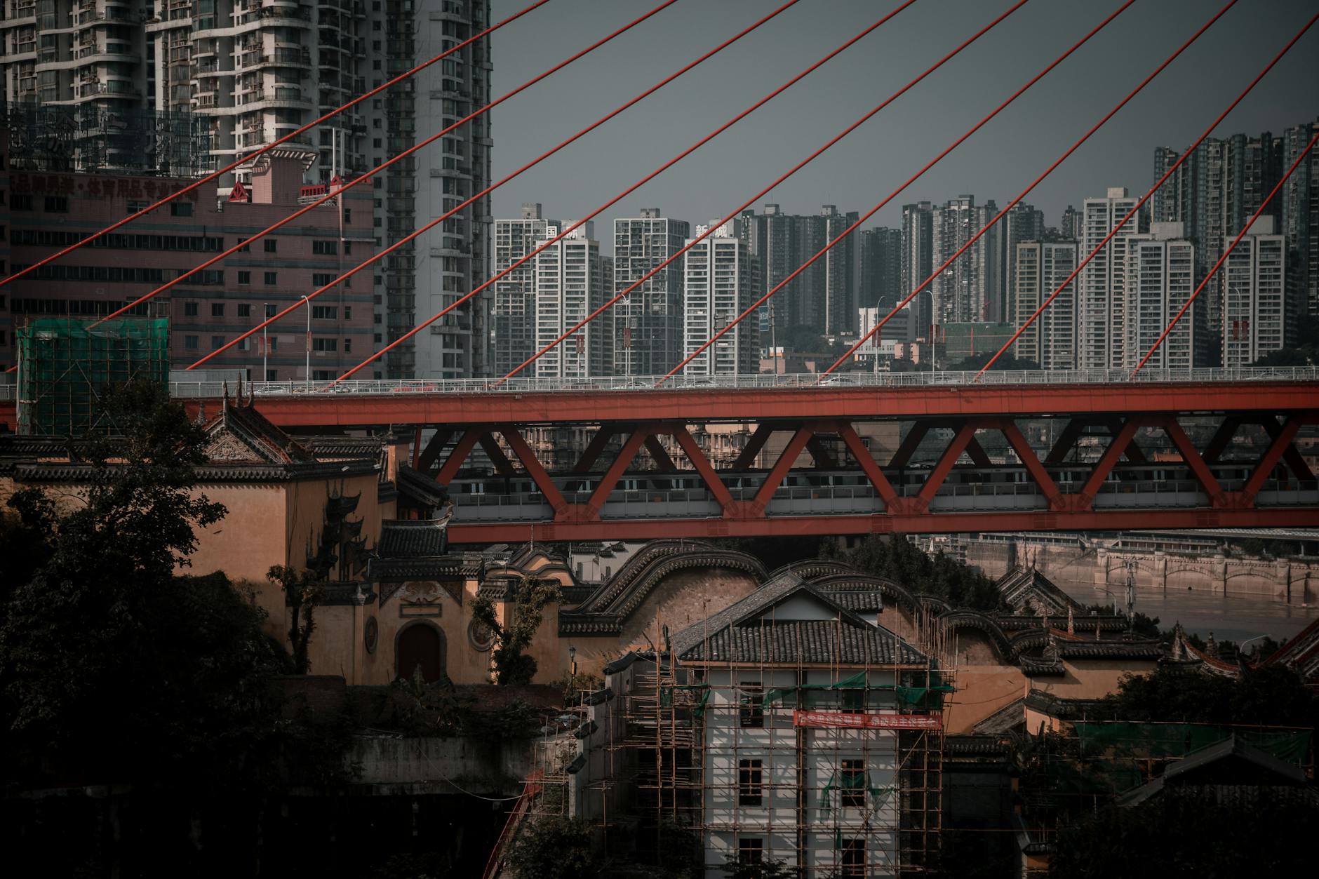Urban scene with a modern suspension bridge and skyline in Chongqing, China.
