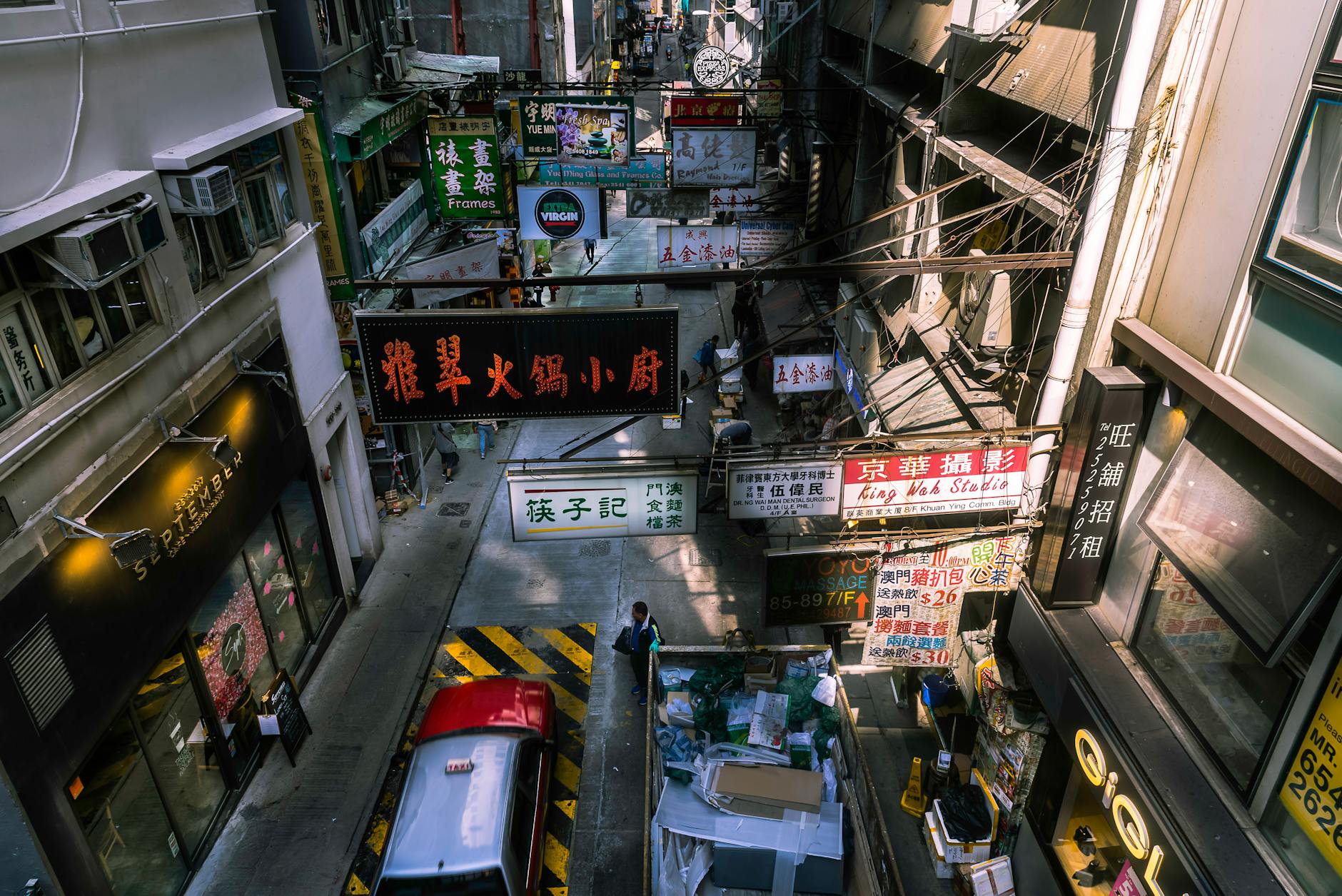 A vibrant view of a busy Hong Kong street market with colorful signage and bustling activity.