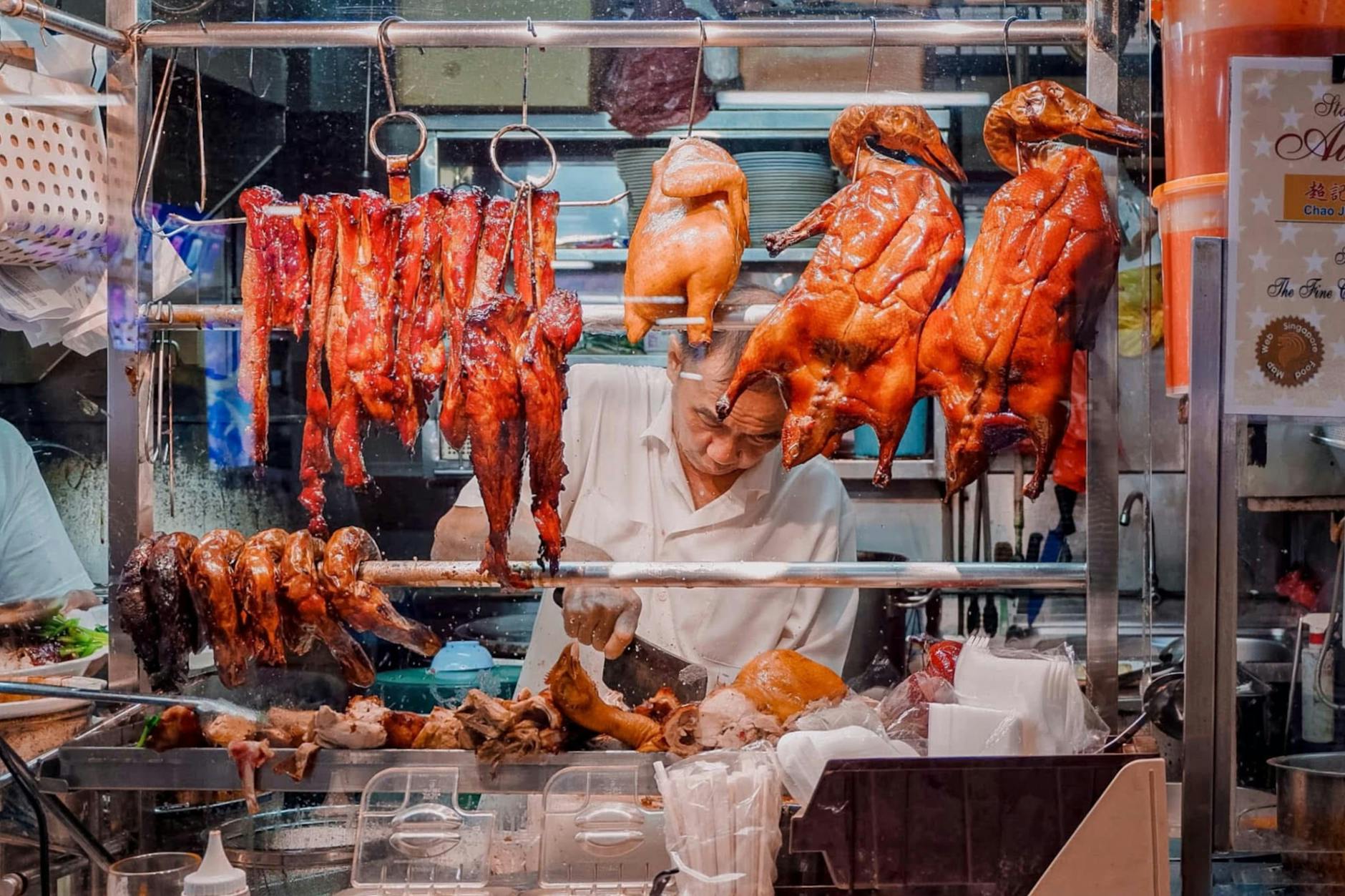 Vibrant market stall with assorted roasted meats, showcasing culinary street food delicacies.
