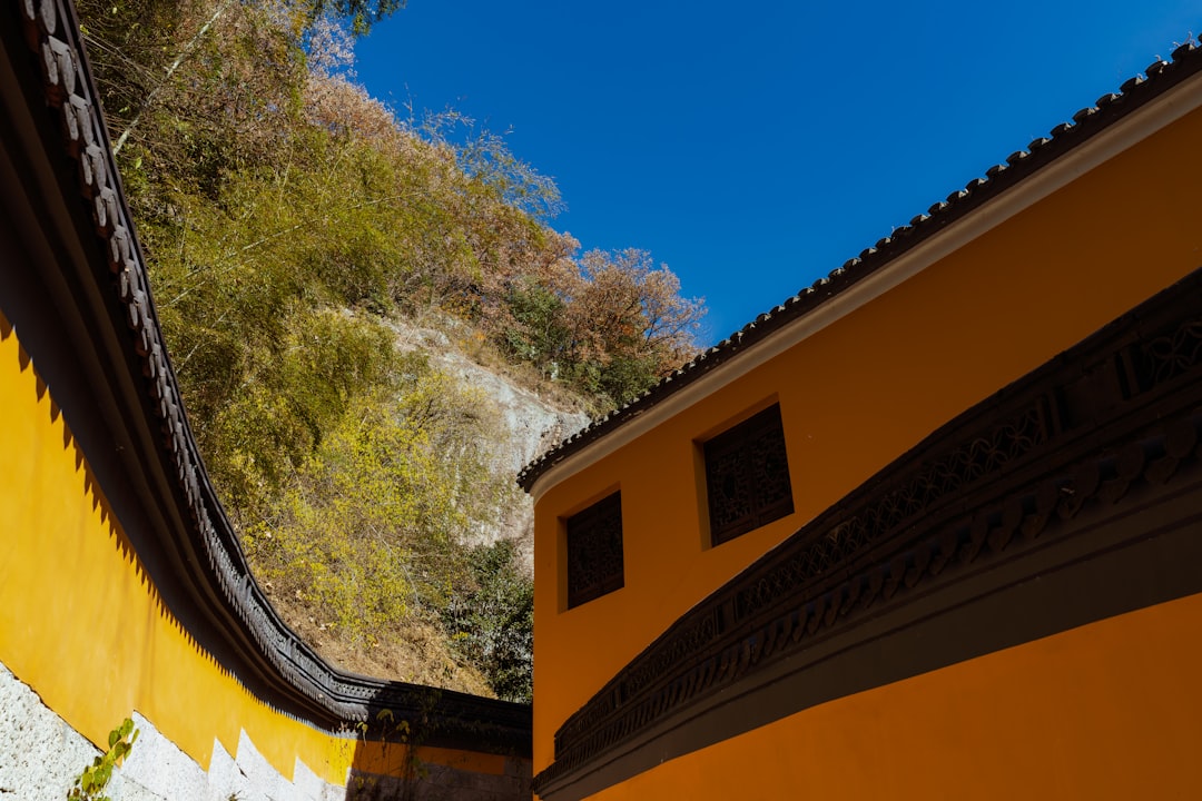 Yellow temple walls with a rocky hillside and blue sky