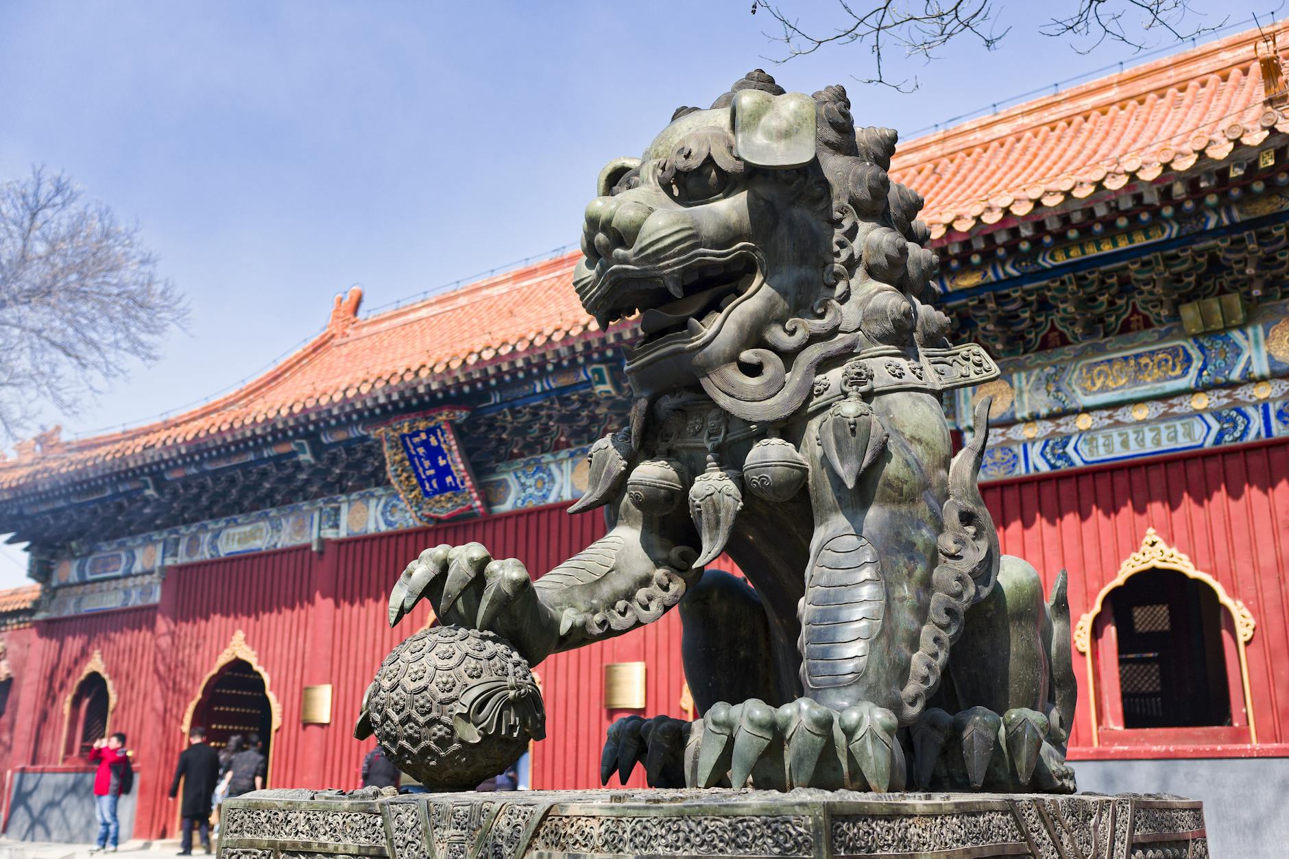 Stone guardian lion statue at a historic temple in Beijing, showcasing traditional Chinese architecture and intricate design.