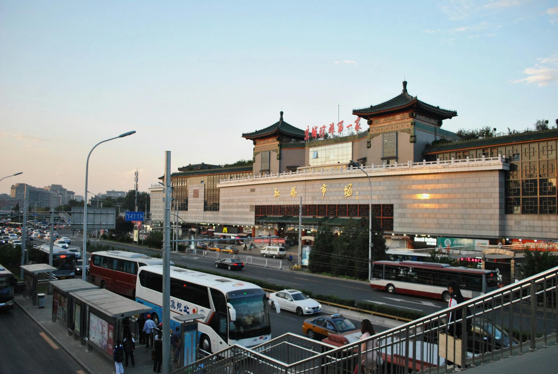 View of Xi'an City Wall at sunset with bustling traffic and traditional architecture.