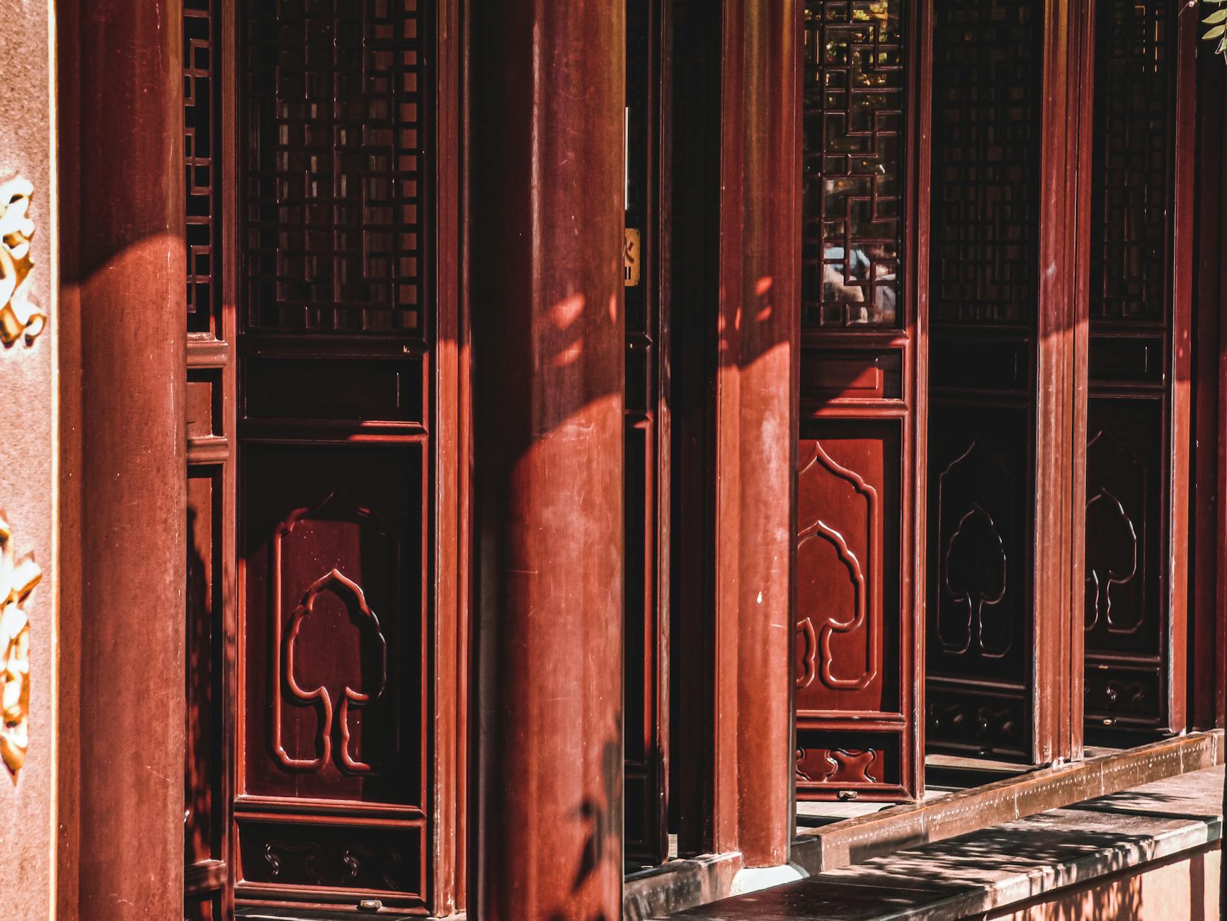 Elegant red wooden windows showcasing traditional Chinese design in Shanghai.