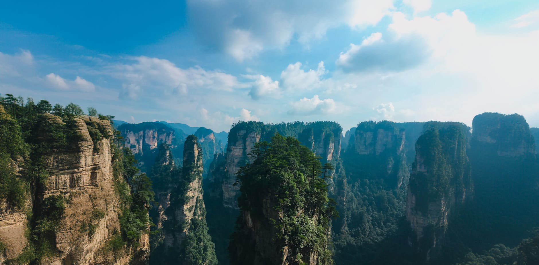 Explore the stunning rock formations and lush forests of Zhangjiajie in Hunan, China.